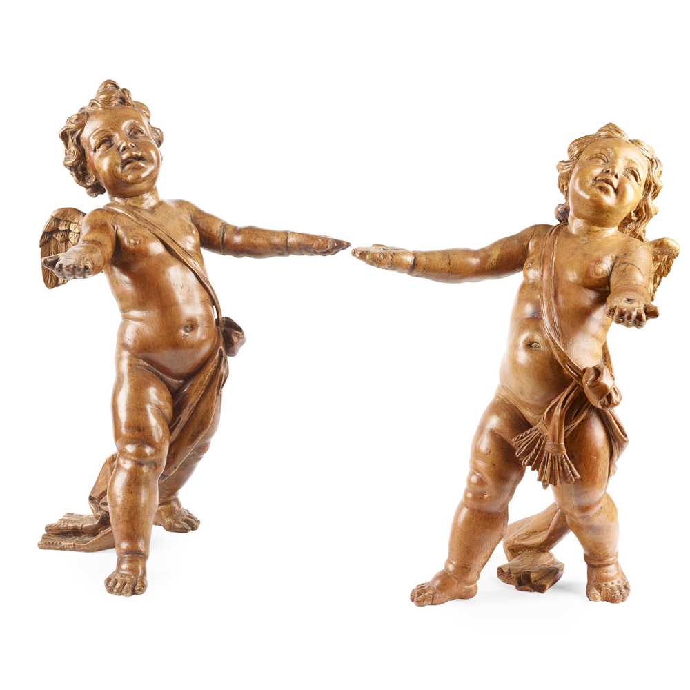 Appraisal: PAIR OF ITALIAN CARVED PINE PUTTI TH CENTURY each draped