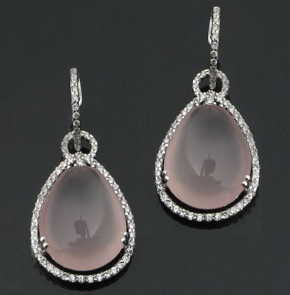 Appraisal: A pair of pave diamond and rose quartz earrings centering