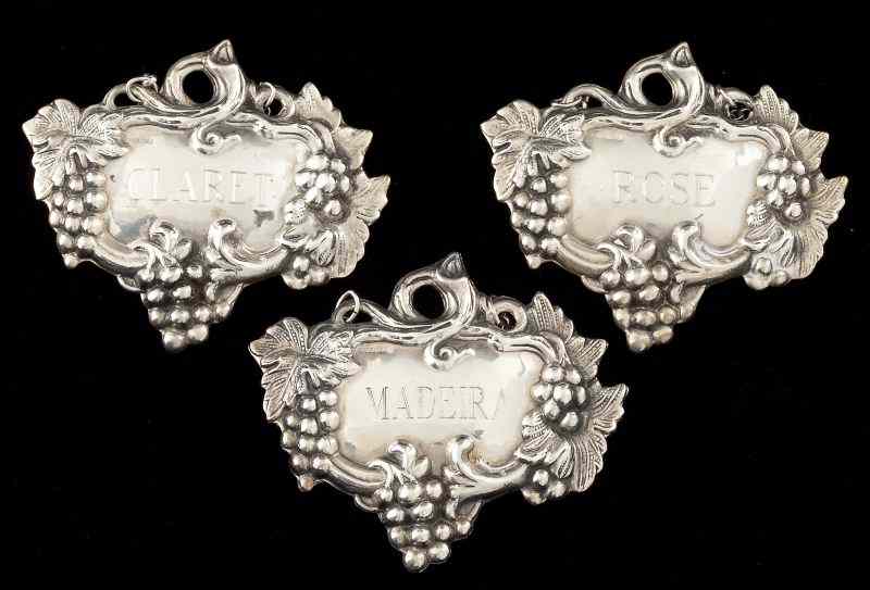 Appraisal: Three Sterling Decanter Labelseach with grape motif engraved ''Claret ''