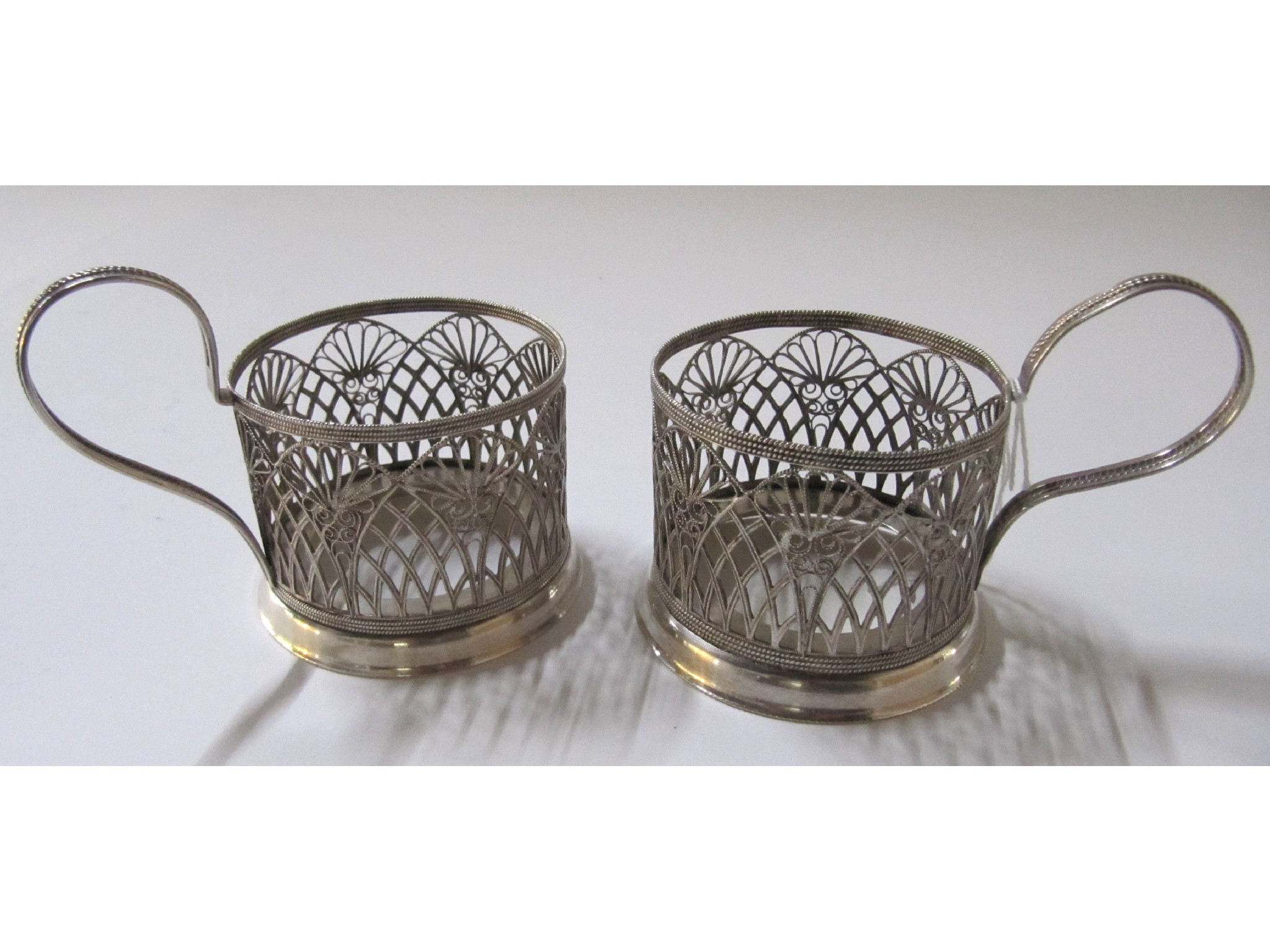 Appraisal: A pair of unmarked filigree silver cup holders