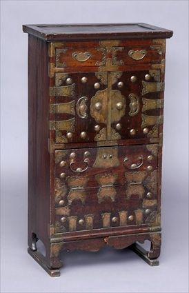 Appraisal: KOREAN BRASS-MOUNTED STAINED WOOD TALL CHEST The overhang top above