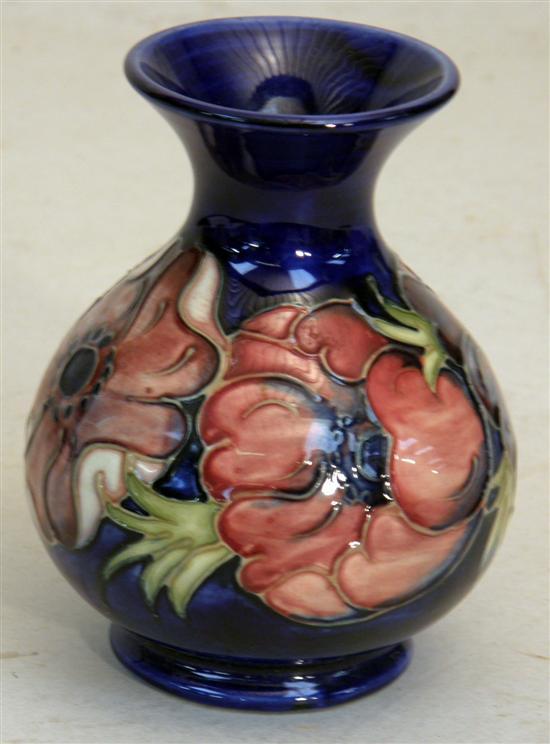 Appraisal: Moorcroft vase decorated with pink poppies on dark blue ground