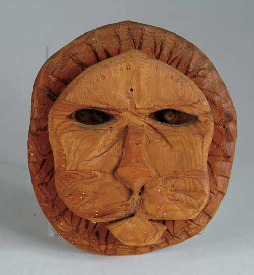 Appraisal: BERNARD LANGLAIS American - LION FACE Carved wood hanging sculpture