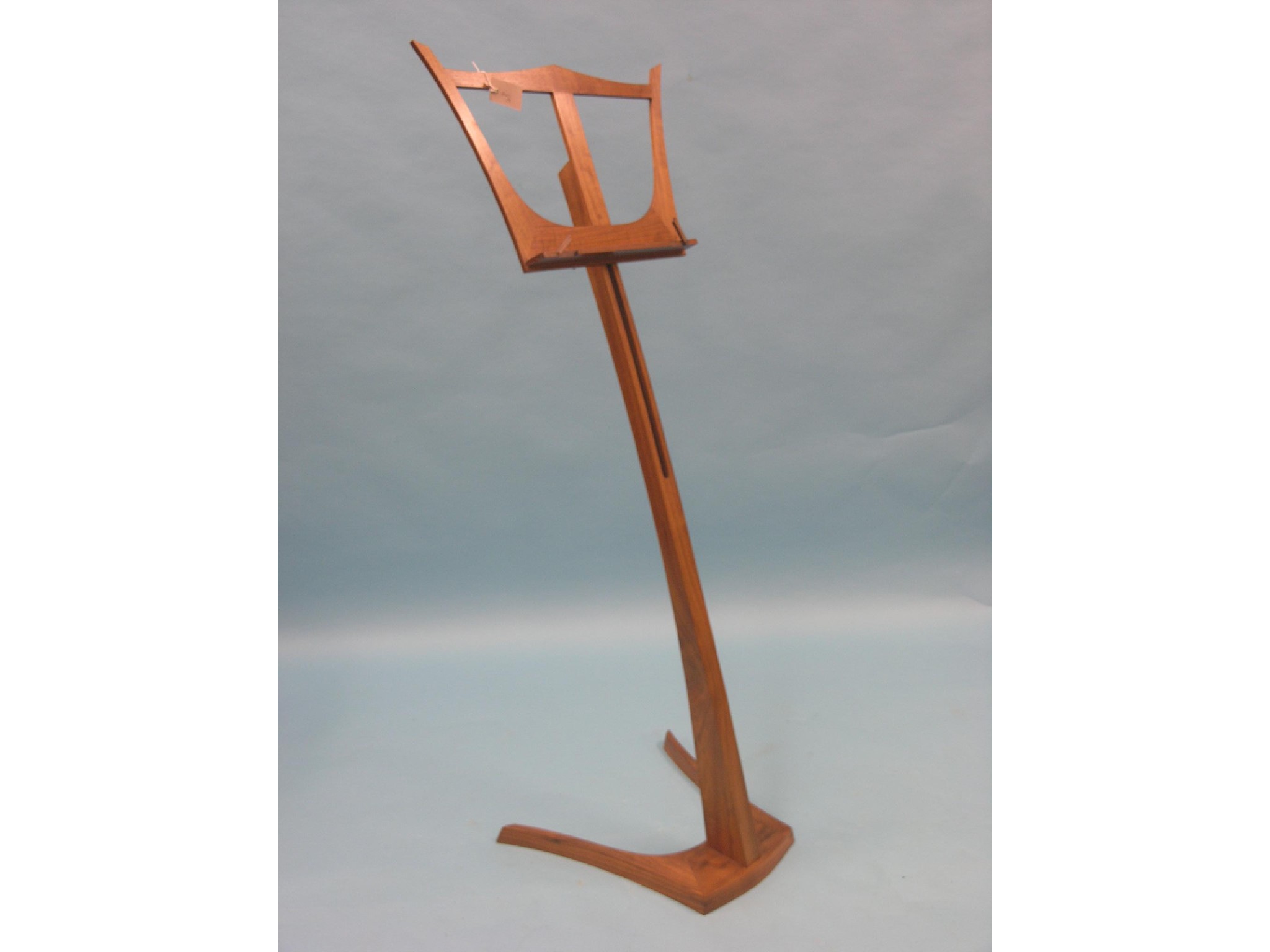 Appraisal: A contemporary walnut music stand with height adjustment by Tim