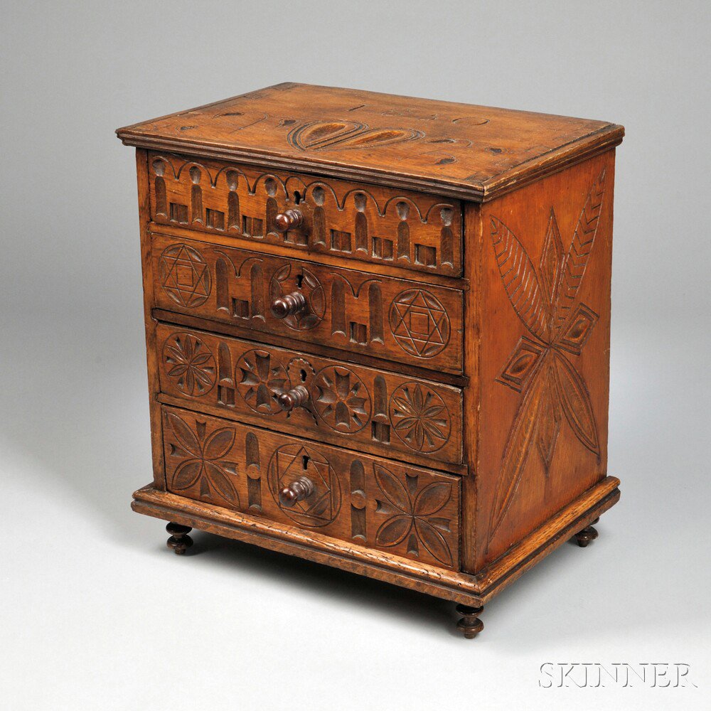 Appraisal: Folk-carved Miniature Four-drawer Chest the elaborately carved case with vines