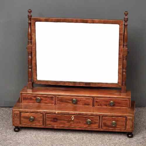 Appraisal: A George III mahogany rectangular toilet mirror on turned uprights