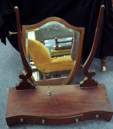 Appraisal: A Victorian mahogany and satinwood crossbanded toilet mirror the shield