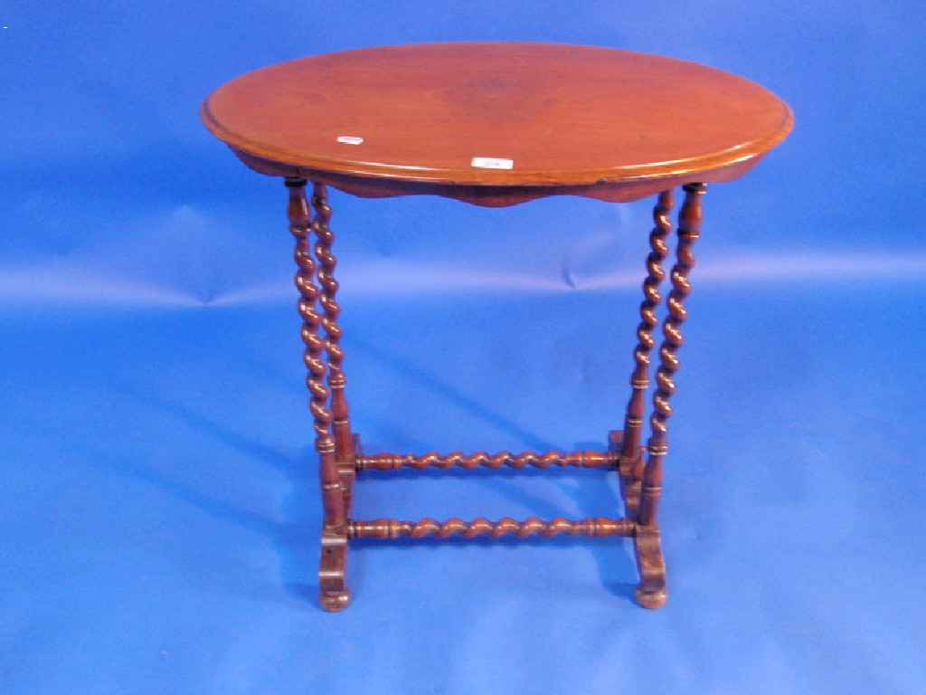 Appraisal: A Victorian walnut occasional table with oval moulded top shaped