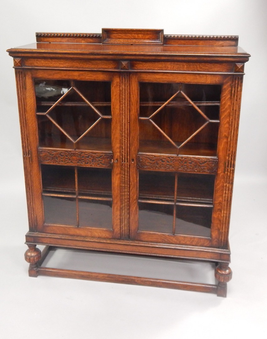 Appraisal: A s oak bookcase with low gallery back and enclosed