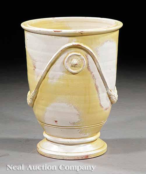 Appraisal: A Tuscan Faience Urn pale yellow and cr me glazes