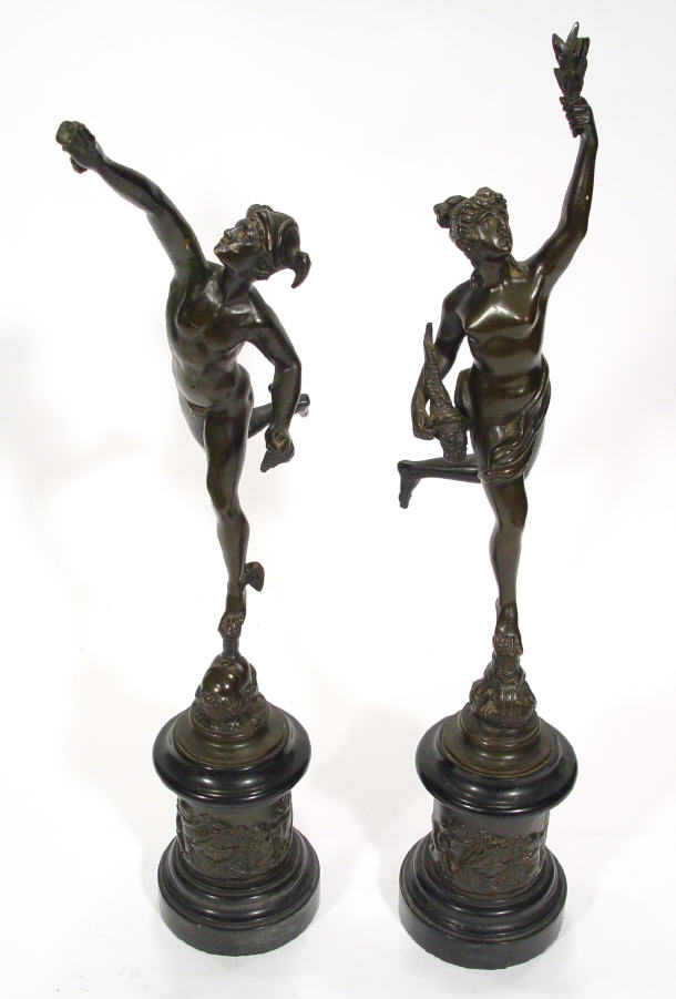 Appraisal: Pair of Roman style bronze figures clutching torches on black