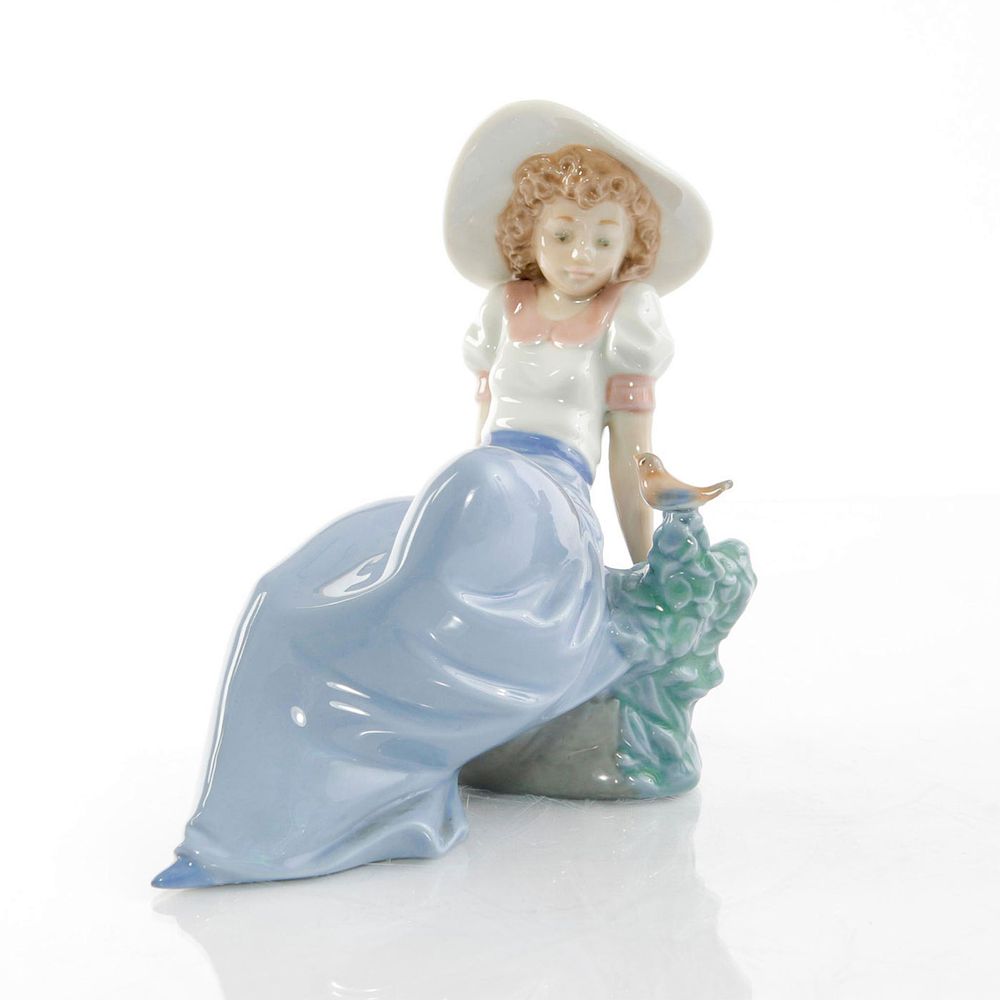 Appraisal: NAO BY LLADRO FIGURINE GIRL WITH BIRD Young girl in