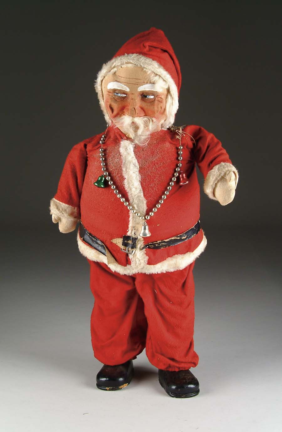 Appraisal: SANTA A masked face Santa on a cloth body with