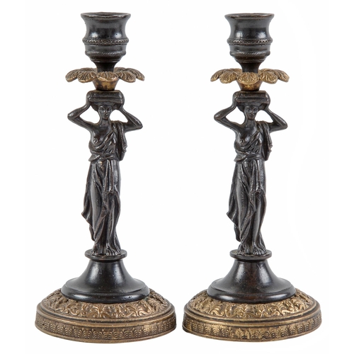 Appraisal: A pair of French parcel gilt bronze caryatid candlesticks th