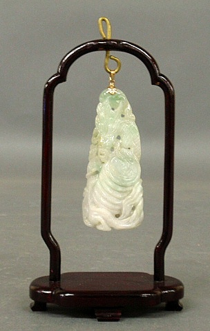 Appraisal: - Carved jade dragon pendant mounted on a wood display