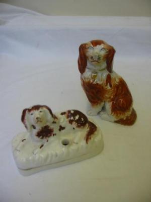 Appraisal: A STAFFORDSHIRE PORCELAIN INKWELL modelled as a reclining spaniel on