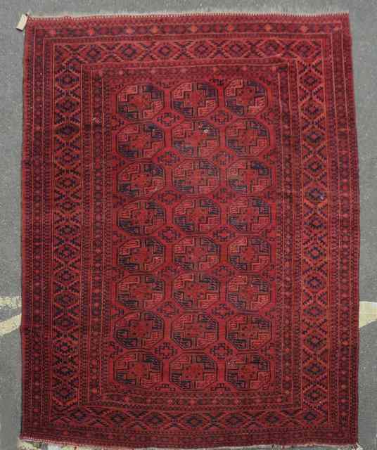 Appraisal: AN OLD AFGHAN CARPET decorated three rows of eight octagons