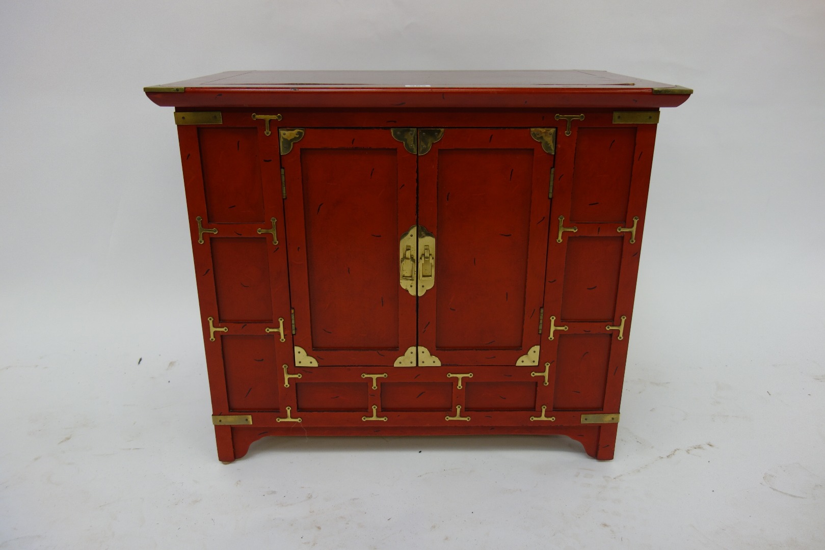 Appraisal: A Korean style crimson lacquer low chest th century enclosed