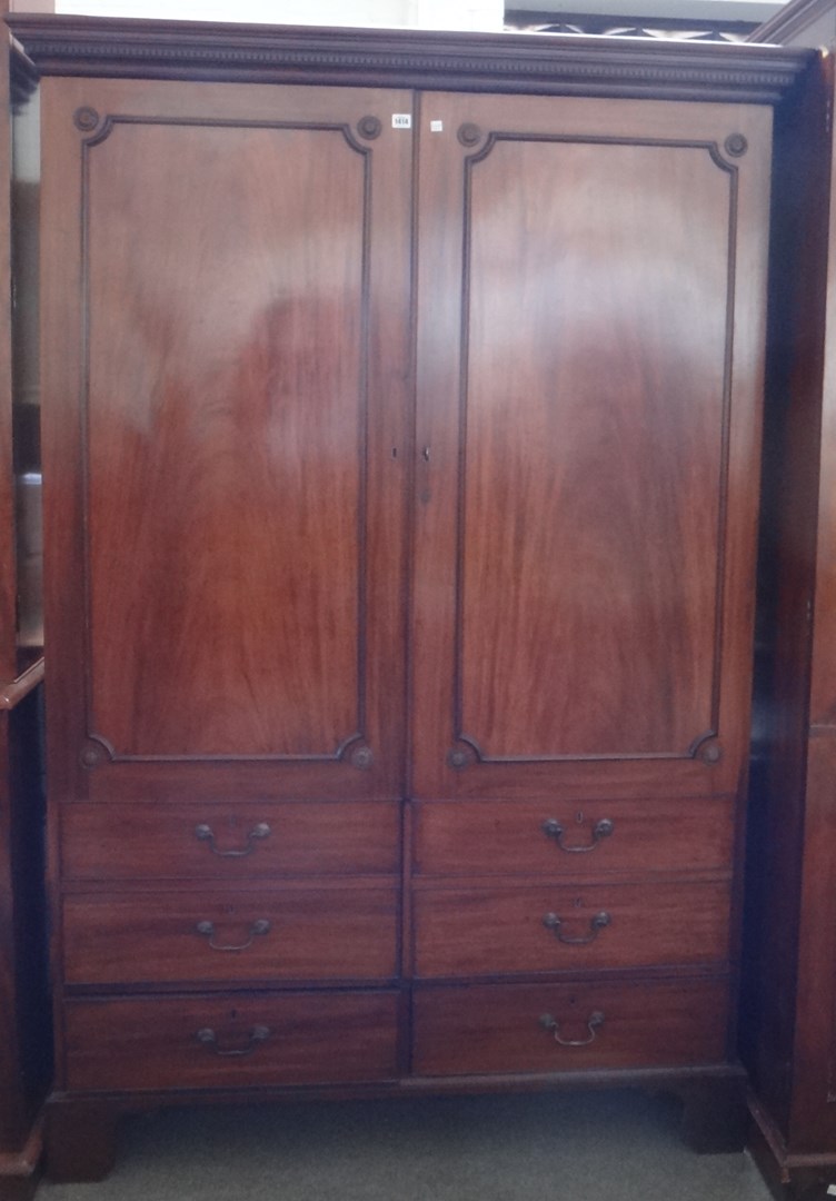 Appraisal: A George III mahogany hall cupboard the pair of doors