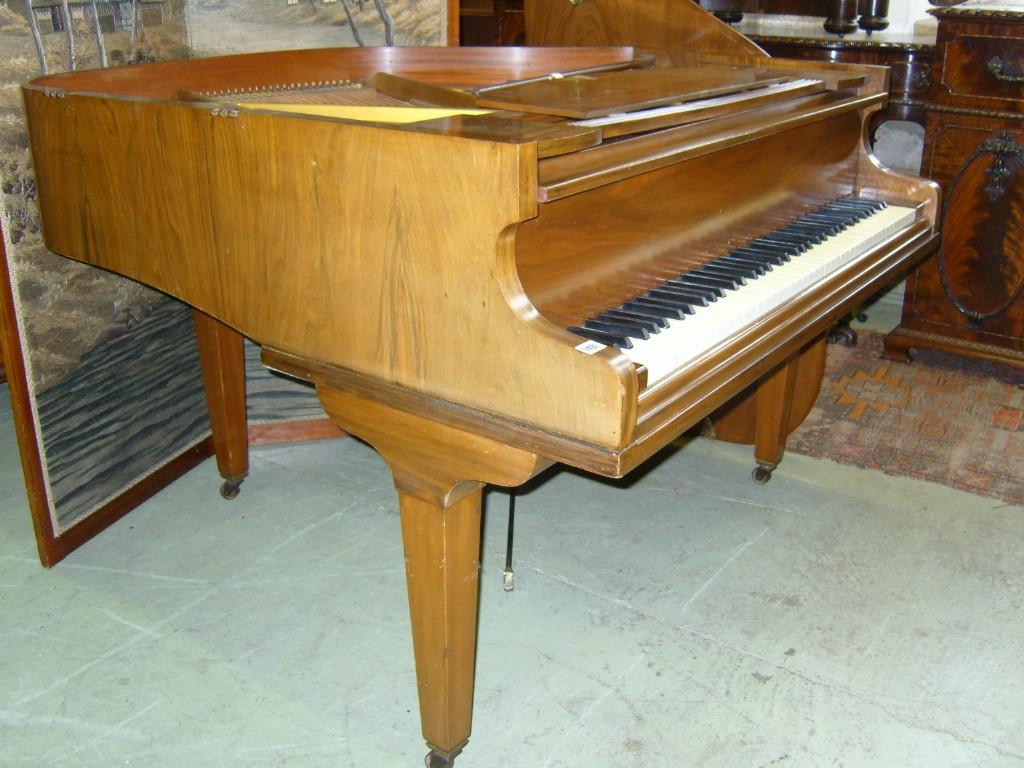 Appraisal: A Baby Grand Piano in a polished walnut case with