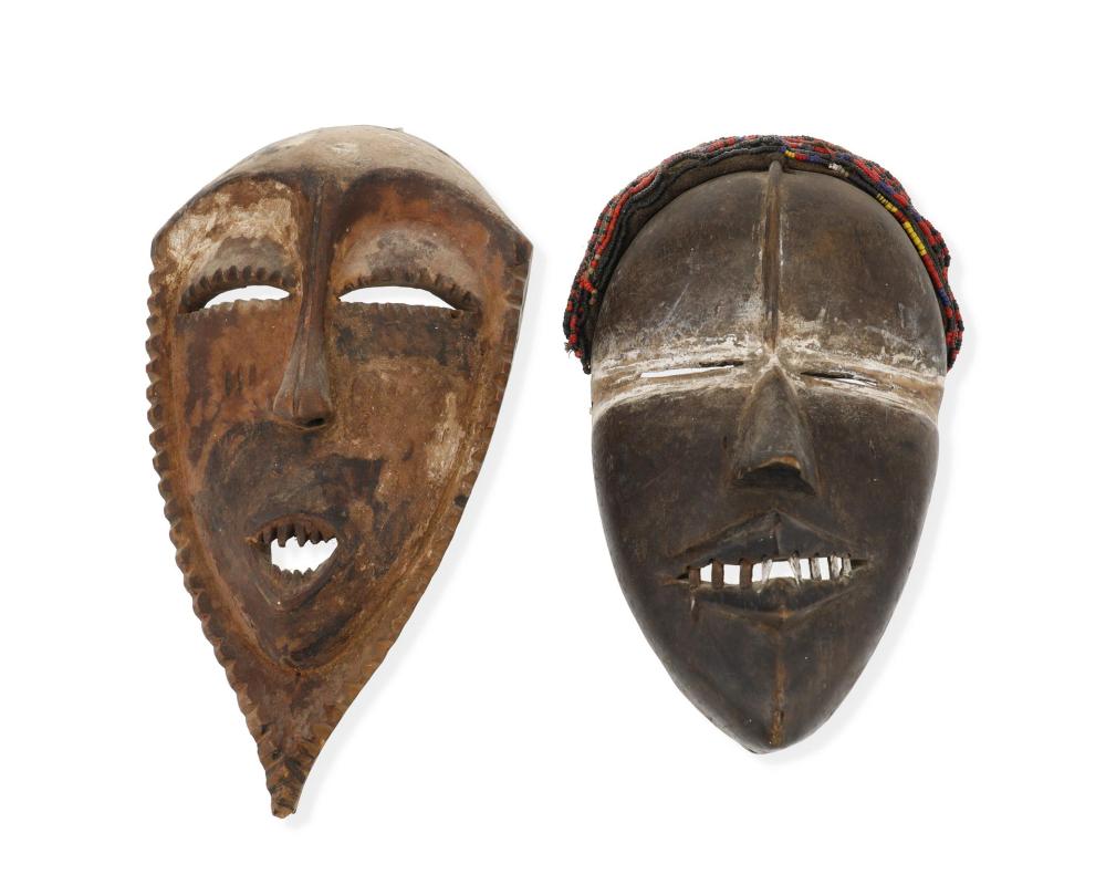 Appraisal: Two African carved wood figural masks th Century Each with