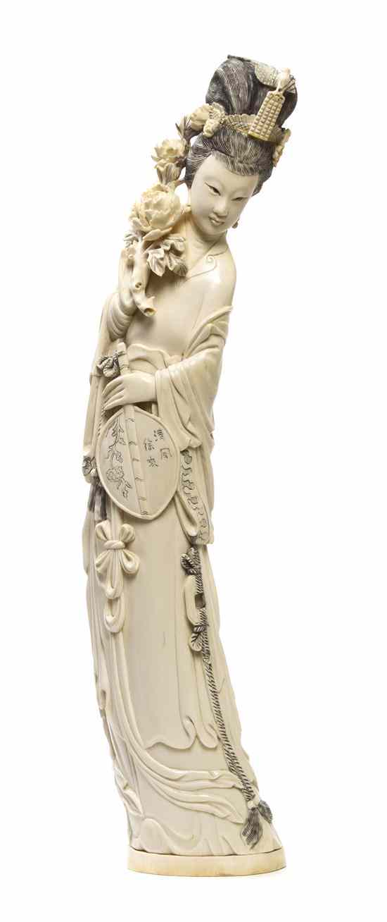 Appraisal: A Chinese Carved Ivory Figure of a Lady depicted raising