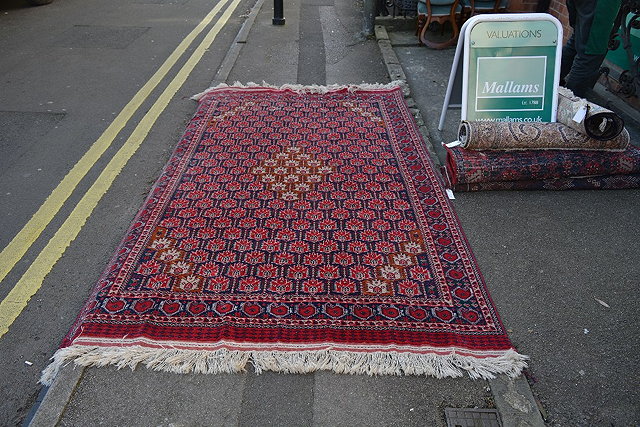 Appraisal: A Turkoman red ground small carpetwith allover stylised medallion cm