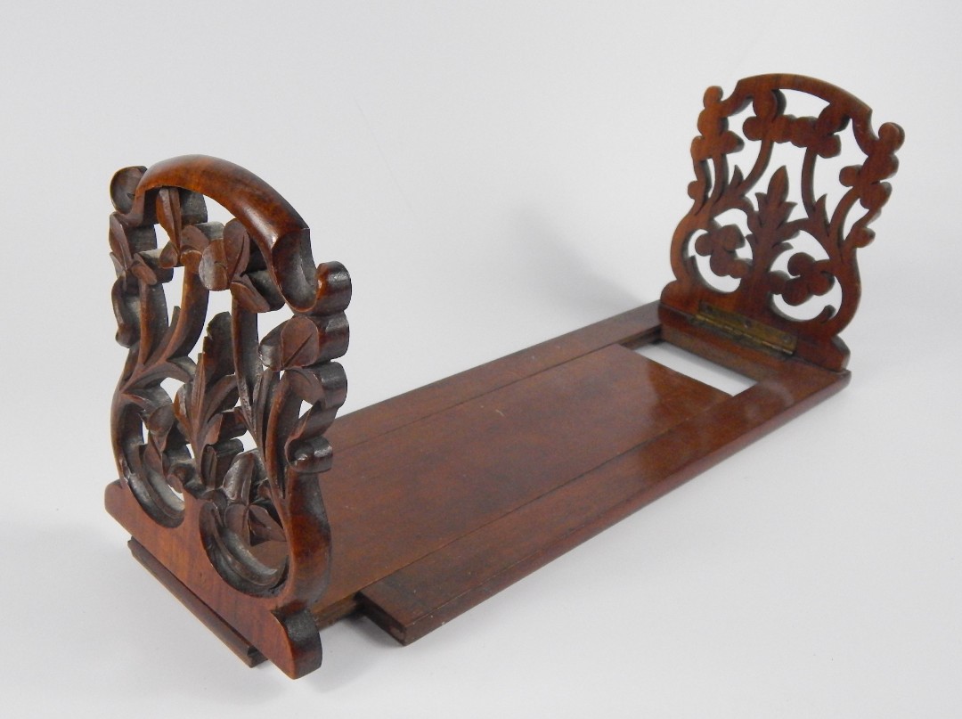 Appraisal: A Victorian walnut and mahogany book slide carved with clover