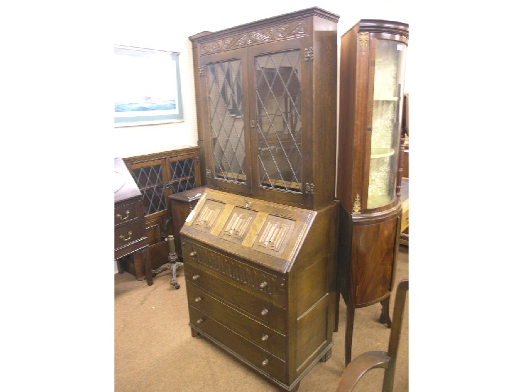 Appraisal: A Jaycee dark oak bureau bookcase pair of leaded glazed