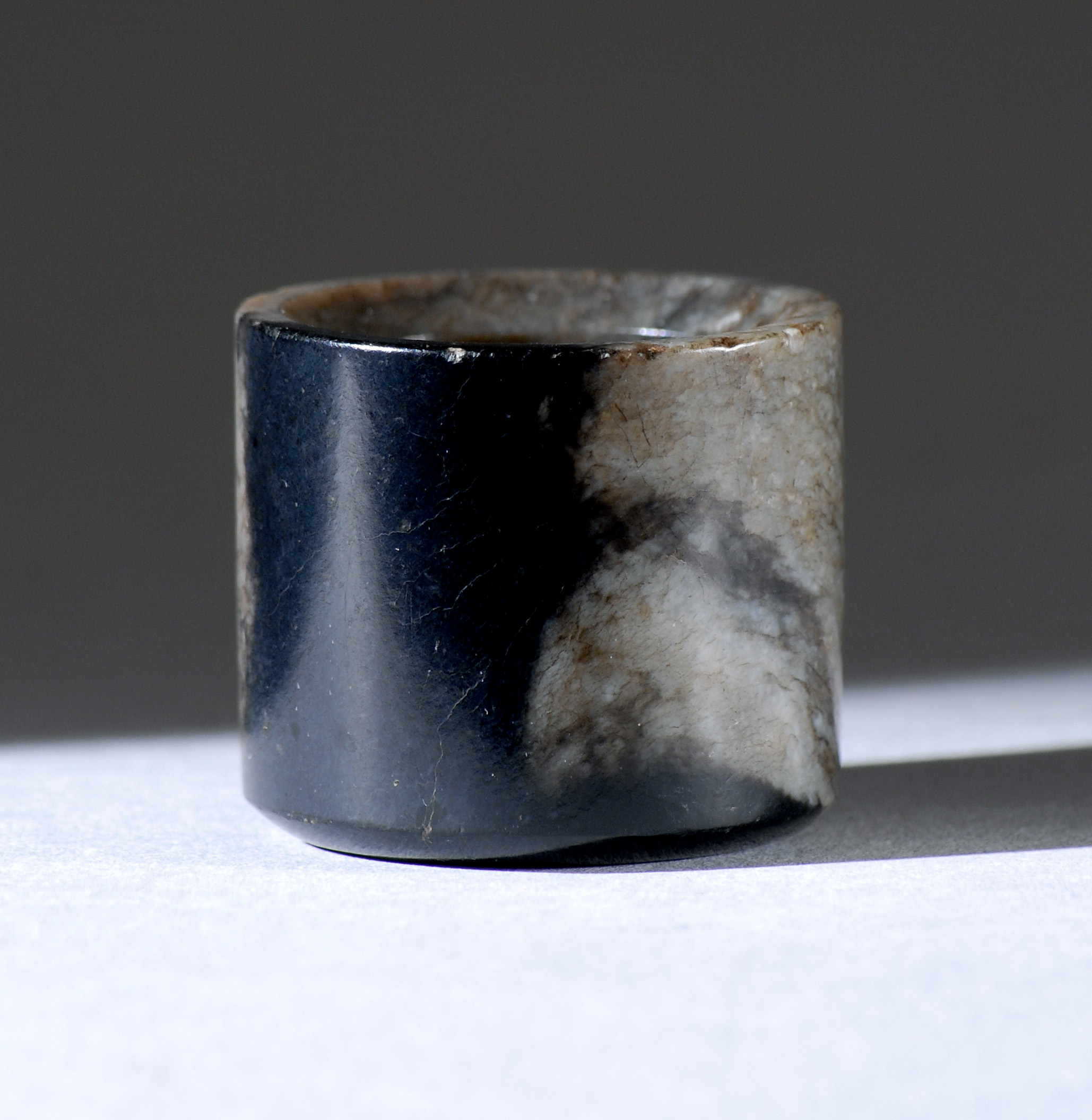 Appraisal: BLACK AND GRAY JADE ARCHER'S RING th CenturyWith a black