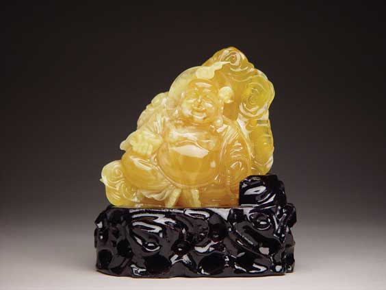 Appraisal: CARVED AMBER BUDAI Well carved Chinese amber figure of a