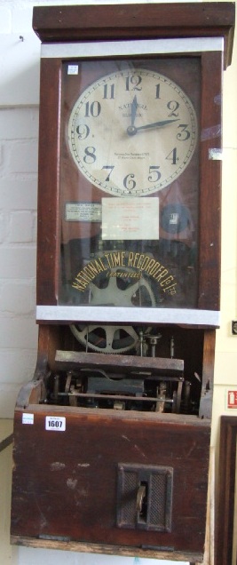 Appraisal: A th century oak framed clocking in machine by 'National