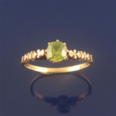 Appraisal: A Russian gold ring mounted with a circular cut demantoid