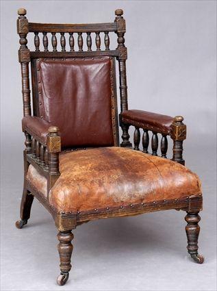 Appraisal: ENGLISH EASTLAKE CARVED OAK ARMCHAIR With nailed leather back padded