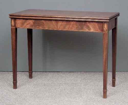 Appraisal: A George III mahogany rectangular tea table with plain folding