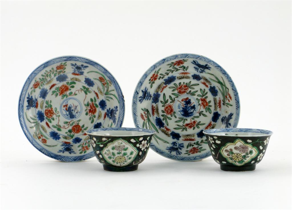 Appraisal: A pair of Chinese famille noire tea bowls and saucers