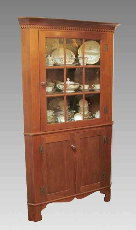 Appraisal: NINE LIGHT CONTEMPORARY CHERRY CORNER CABINET Dentil mold top with