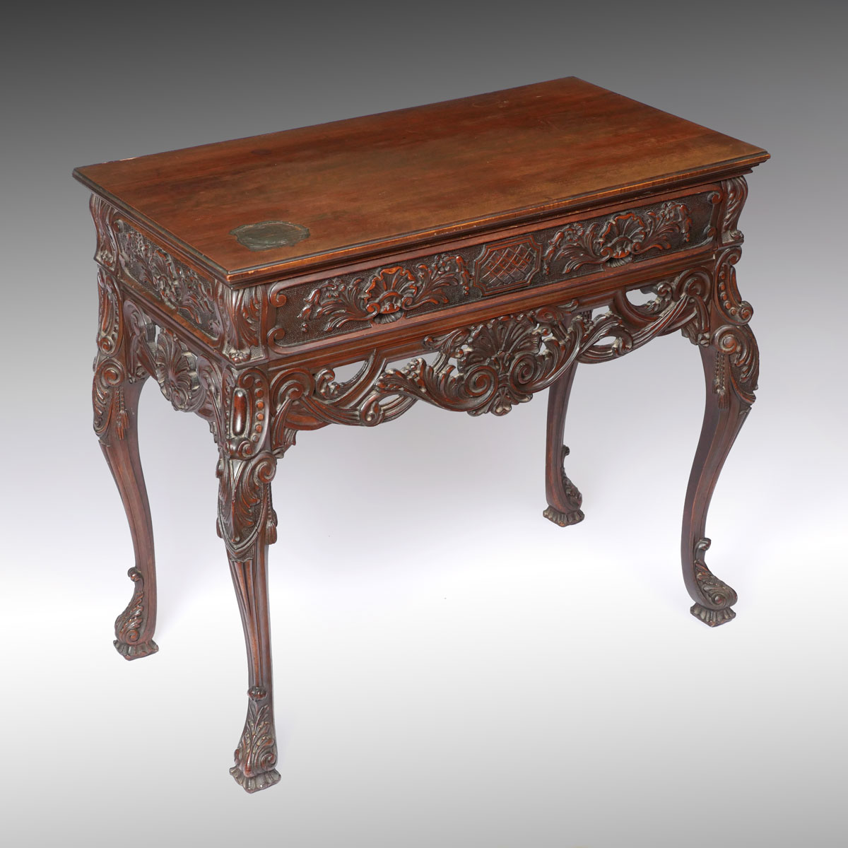 Appraisal: CARVED CREDENZA TABLE Credenza table having an overall Shell medallion