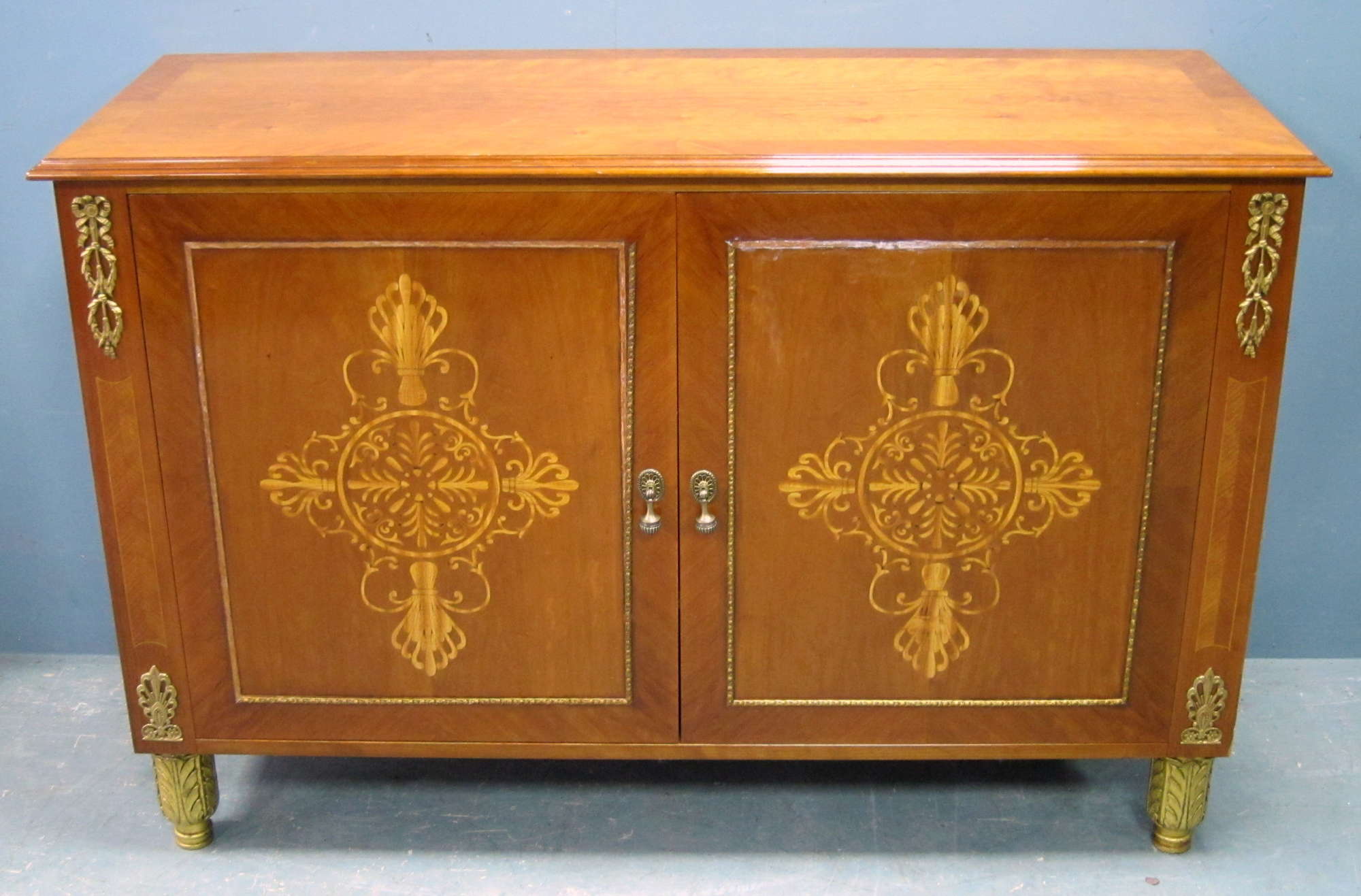 Appraisal: Reproduction mahogany side cabinet with inlaid panelled doors on shaped