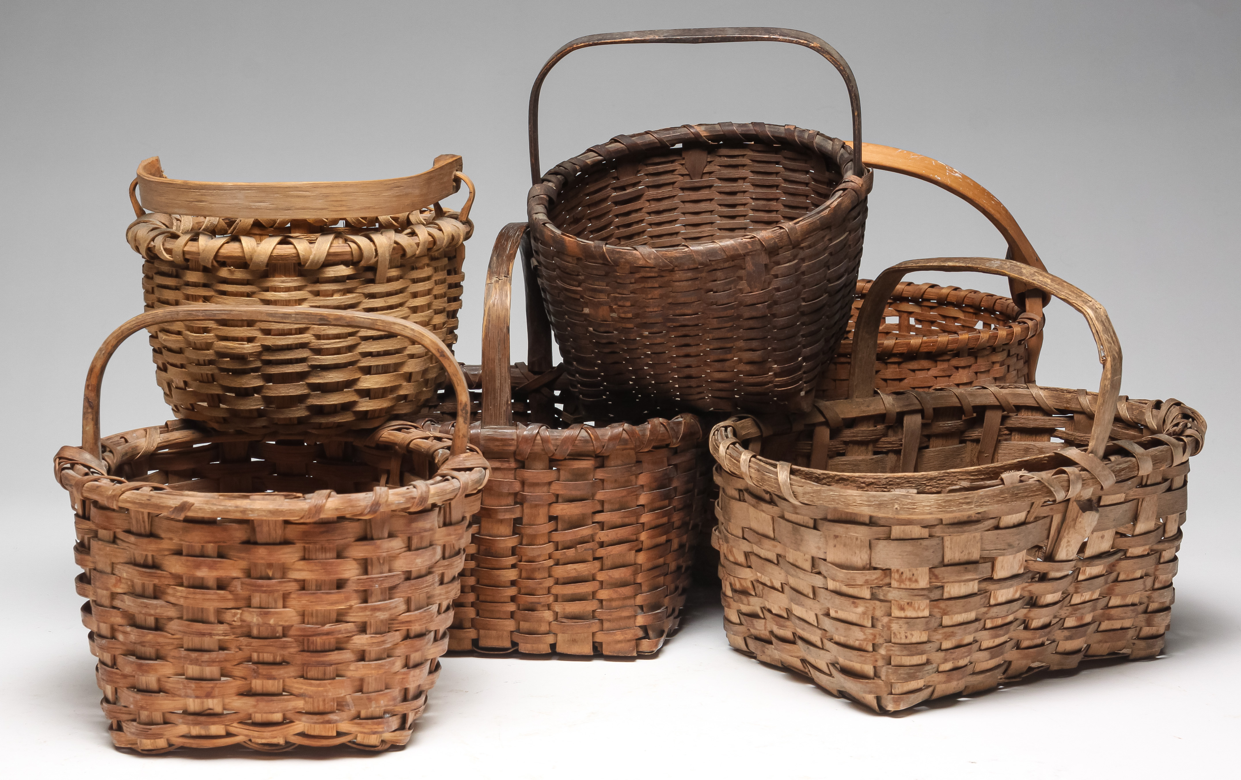 Appraisal: SIX AMERICAN BASKETS Twentieth century Woven splint with bentwood handle