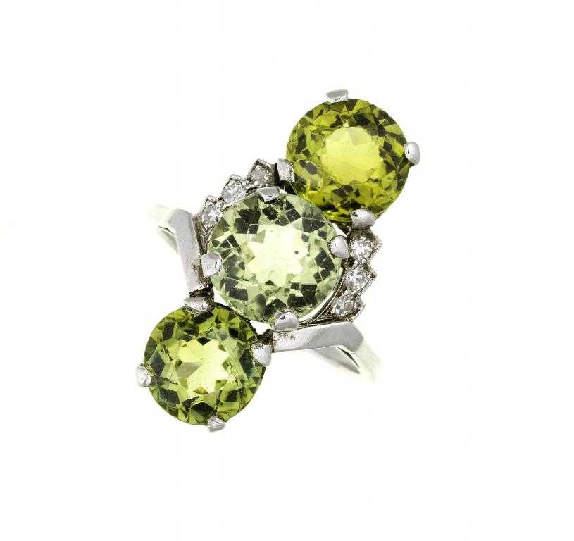 Appraisal: A GREEN ZIRCON AND DIAMOND RING with three larger zircons