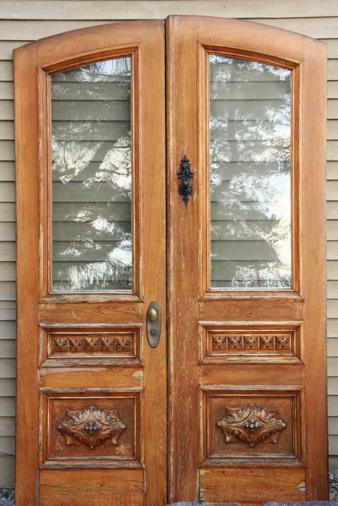 Appraisal: ENTRY DOORS - Matched pair of arch top walnut entry