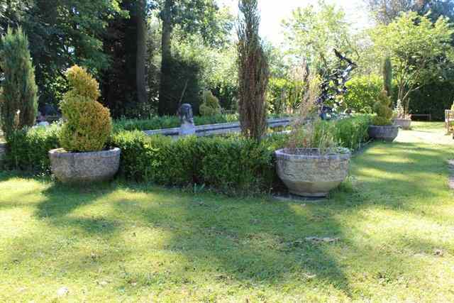 Appraisal: A SET OF FOUR HADDONSTONE SHALLOW PLANTERS with faceted sides