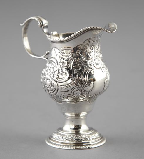 Appraisal: George III Repousse Sterling Silver Footed Cream Pitcher London the