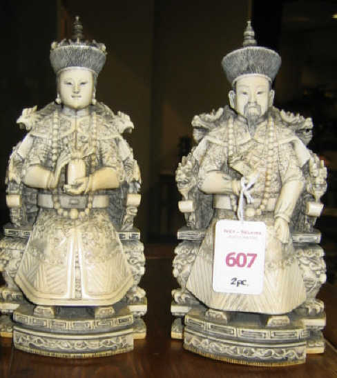 Appraisal: PAIR OF ANCESTRIAL ASIAN CARVINGS Showing a seated man and