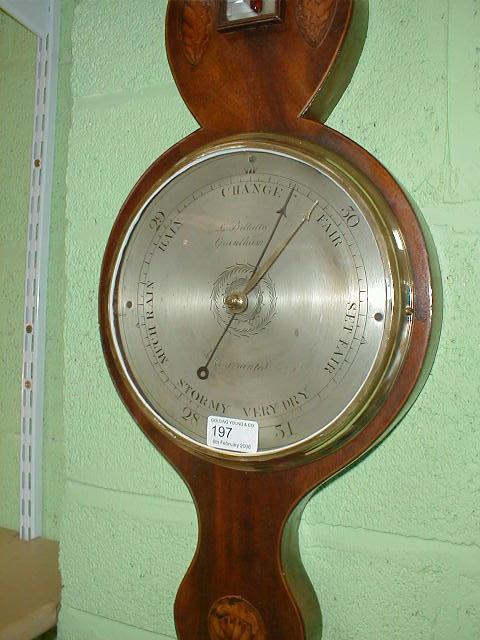 Appraisal: A George III mahogany wheel barometer with broken arch pediment