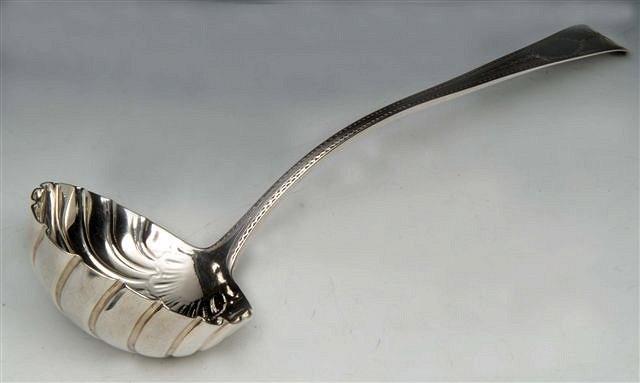 Appraisal: A GEORGE III IRISH SILVER PUNCH LADLE with scallop shaped