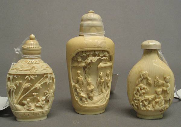 Appraisal: Three carved ivory snuff bottles Two with carved relief decoration