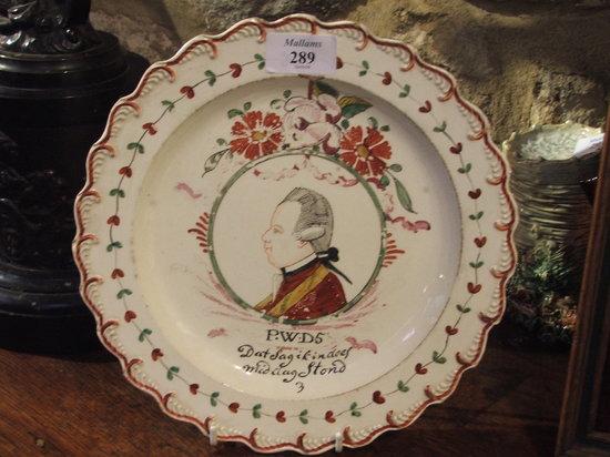 Appraisal: AN OLD CREAMWARE DISH possibly Leeds painted portrait medallion of