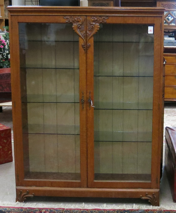 Appraisal: LATE VICTORIAN CARVED OAK CHINA CABINET American c the interior